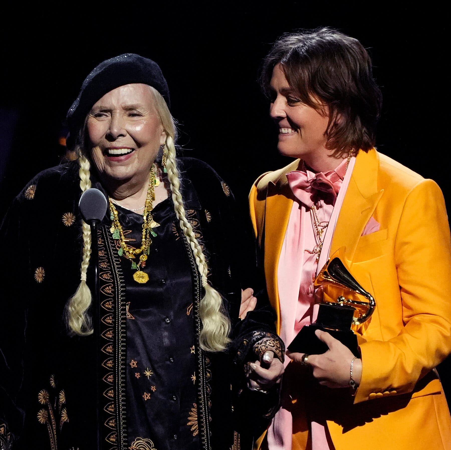 Joni Mitchell was joined by Brandi Carlile, accepting a Grammy for best folk album at the preshow.Credit...Chris Pizzello/Invision, via Associated Press