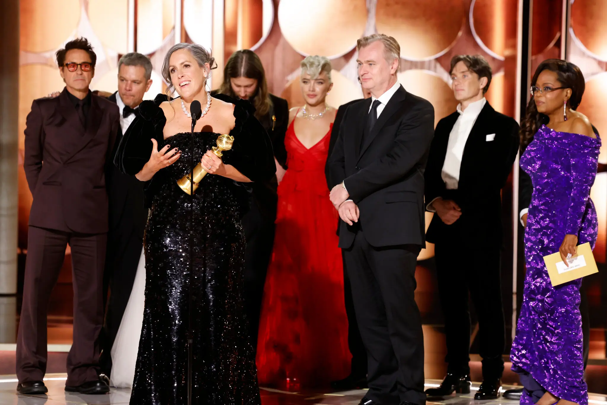 The producer Emma Thomas, front left, accepts the best drama award for “Oppenheimer.”Credit...CBS